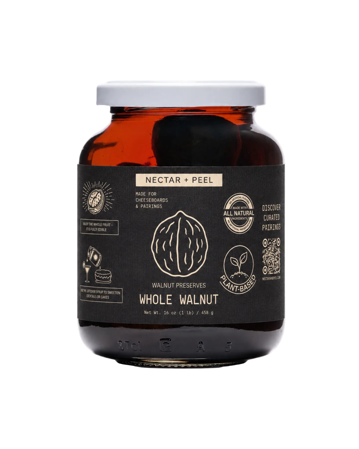 Jar of whole walnuts preserves in syrup with a black label on a white background
