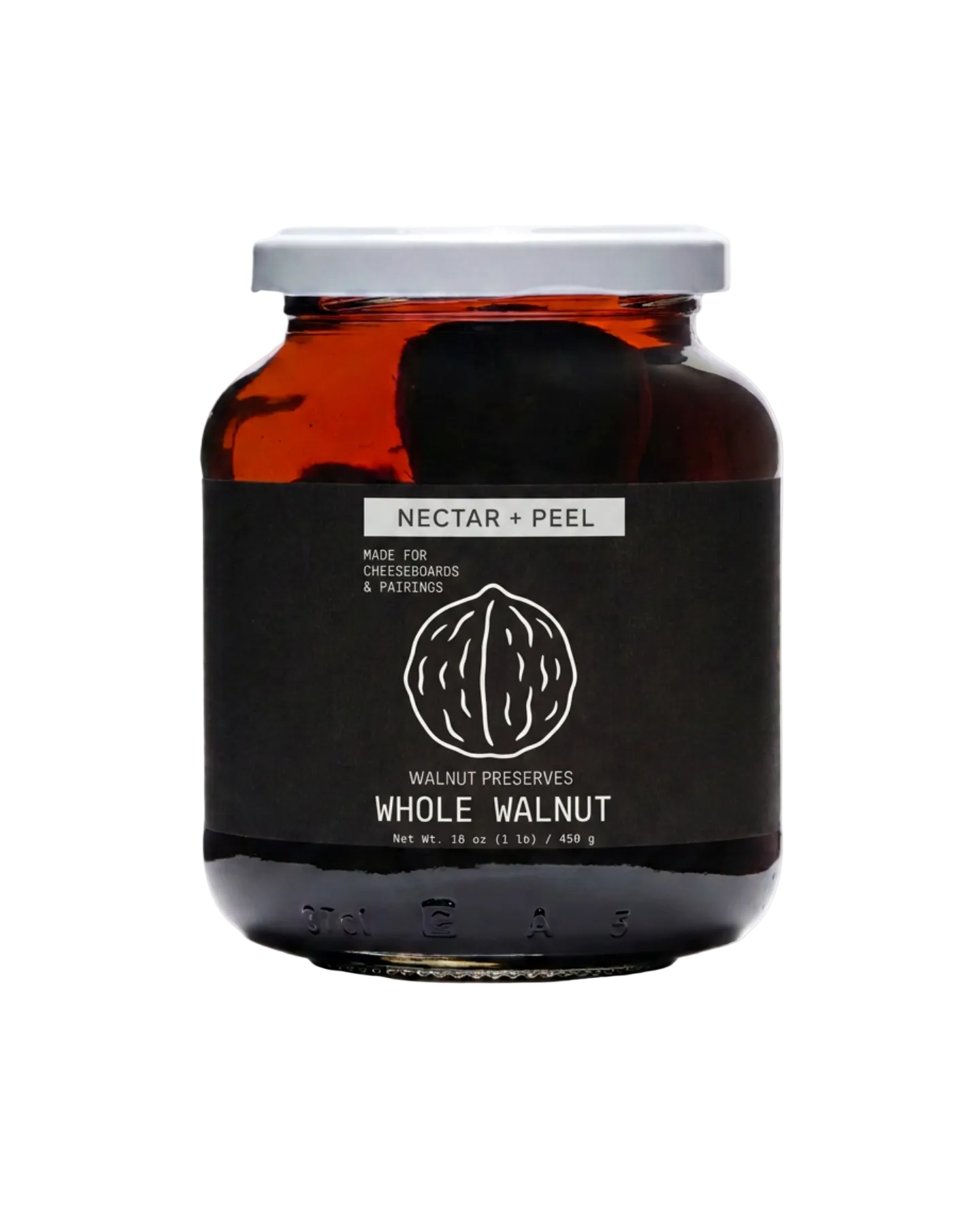 A glass jar of Walnut Preserves with 'Nectar + Peel' on the label, featuring an amber-brown glass body, a black label with white text, and a silver metal lid, set against a plain white background.