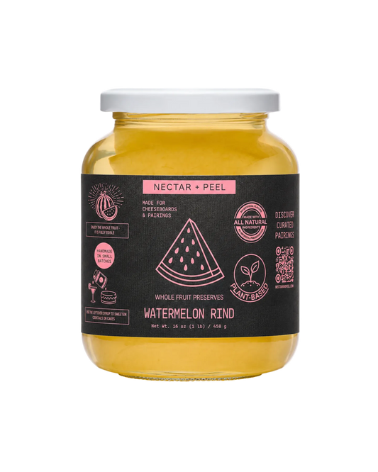 Jar of watermelon rind preserve with a black label on a white background